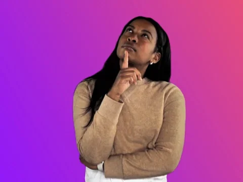 A woman stands with one arm folded and the other resting under her chin, looking upward as she considers a question.