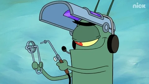 Plankton, from the SpongeBob cartoon, lights a blowtorch with a striker and grins. 