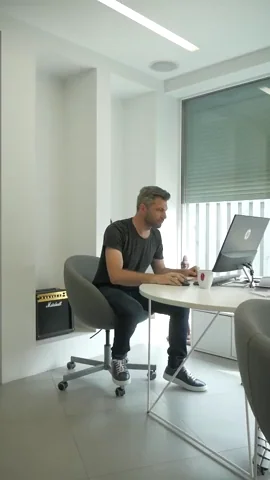 An office worker punches away words that float in front of him: doubts, laziness, distractions, and negativity.