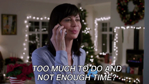 A woman saying into a phone, 'Too much to do and not enough time?'