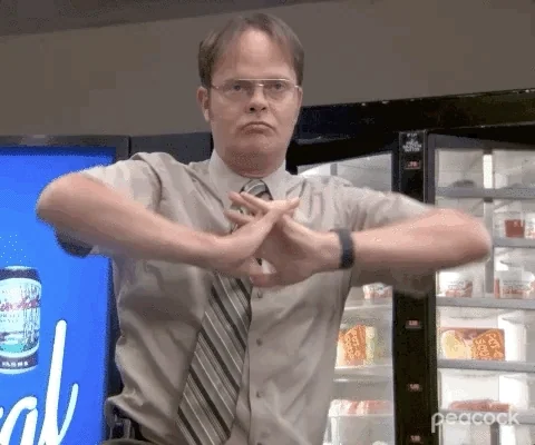 Dwight Schrute from The Office stretching his arms getting ready