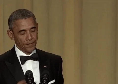 President Obama on stage at an event, dropping the microphone purposely.