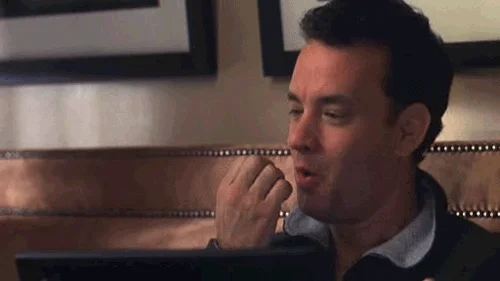 Tom hanks confidently kisses his fingers before pressing send on his computer