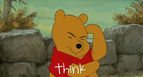 Winnie the Pooh taps his head, thinking.
