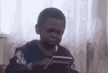 A little boy performs an operation on a calculator and shrieks excitedly when he finds the answer. 
