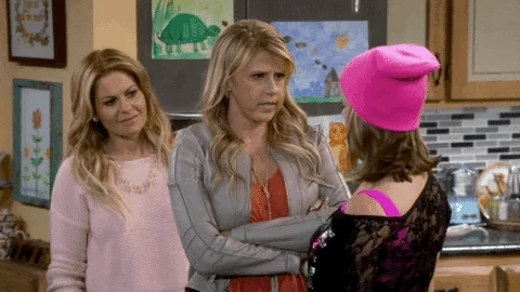 Jodie Sweetin as Stephanie Tanner on Fuller House crossing her arms and telling Kimmy, "How rude!"