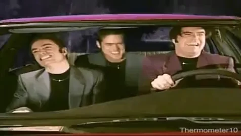 Three men in a car head-banging in sync.