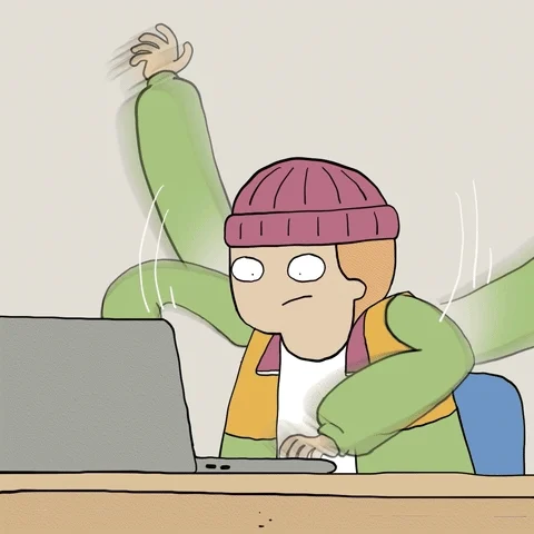 person in hat typing wildly at a computer