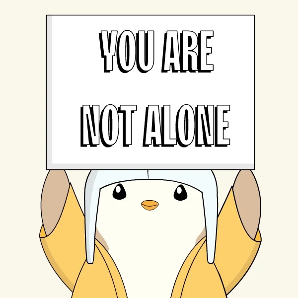 A penguin holding a sign that says 'You are not alone'.