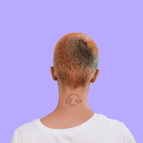 A person with shaved head. The text around them reads: 