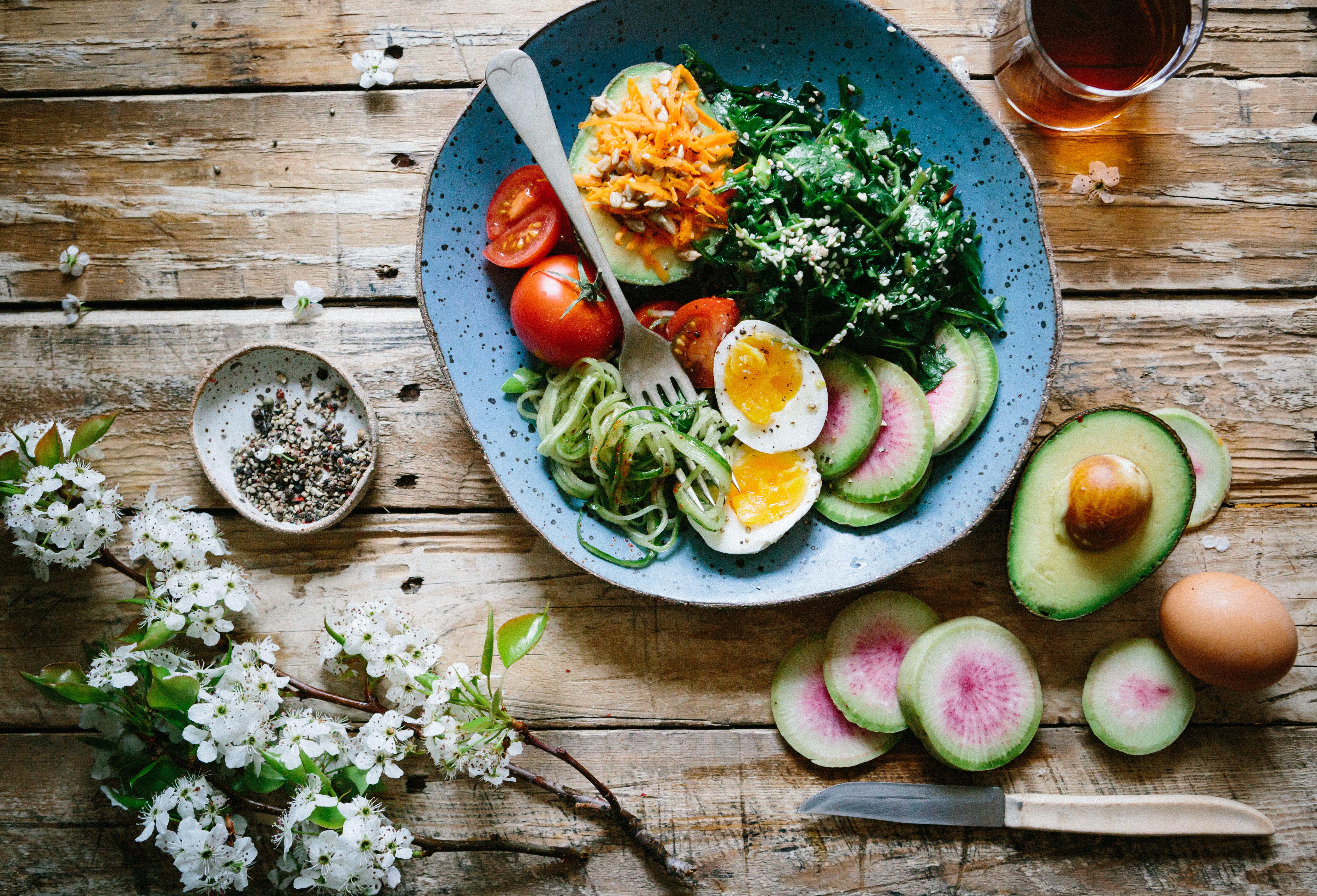 Photo by Brooke Lark on Unsplash. A plate with appetizing food on a wooden table