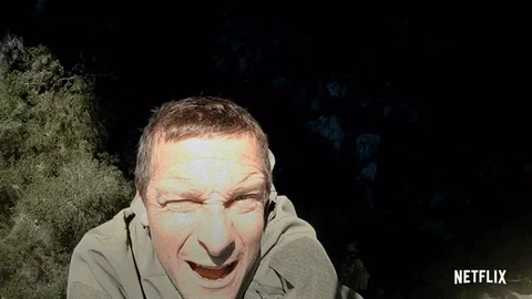 Bear Grylls, from Man VS Wild, climbing a cliff and telling us 
