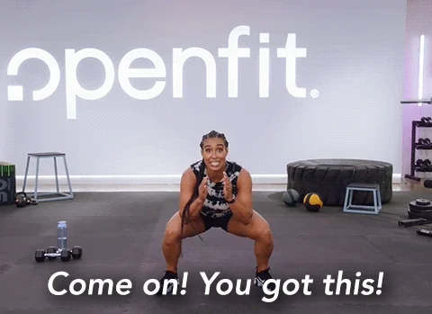 A woman doing squat in a gym. She says, 