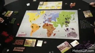 A group of people playing the board game Risk.