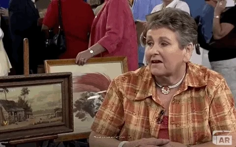 Old woman showing item on Antiques Roadshow and saying, 'This was in a pile of trash.'