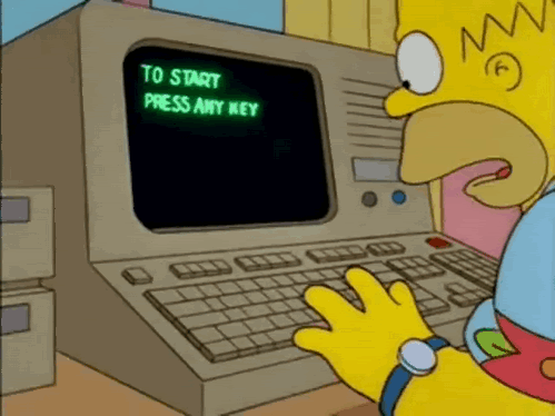 Person typing on a computer. The computer screen displays 'to start press any key'