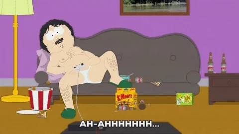 South Park's Randy Marsh plays video games laying down on the couch. Food is scattered everywhere.