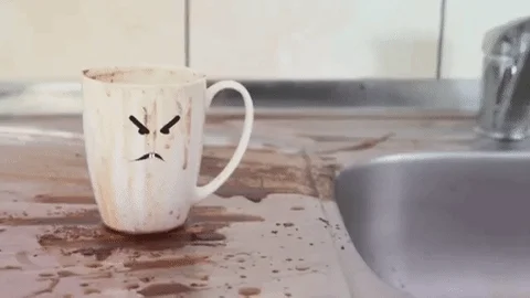 An animation depicting a dirty teacup on a dirty counter.