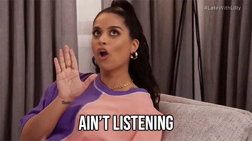 Lily Singh rolling her eyes, putting up a hand, and saying, 