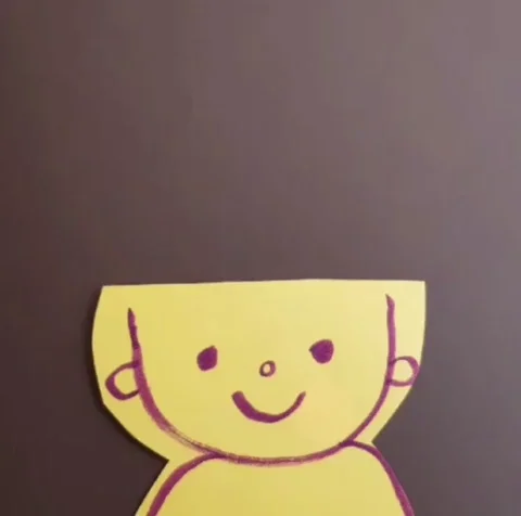 A child's drawing of a yellow smiling face with popping colourful paper cut-outs symbolizing a burst of ideas.