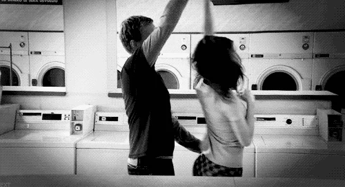 A couple dancing in a laundry.