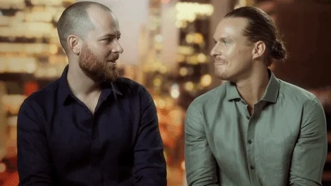 A man looking at another man and then saying, 