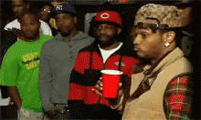If You Say So Reaction GIF (Man holding a red cup scoffing and walking away from the group)