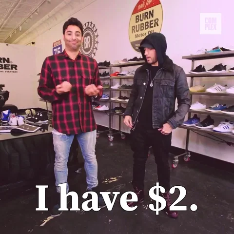 Two men in a shoe store. One pulls cash out of his pocket and says 