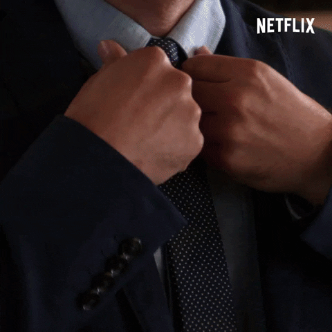 A person adjusting their clothes and hair before a job interview
