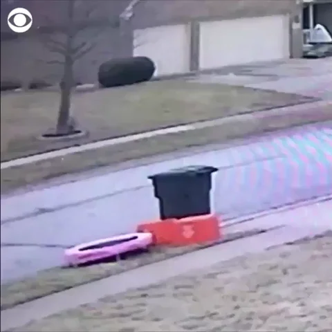Sanitation worker jumping on a trampoline and then throwing away trash into a garbage truck.