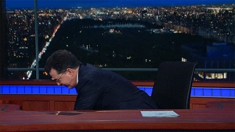 Stephen Colbert furiously punching a calculator.