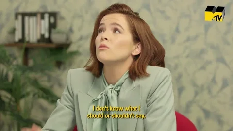 Actress Zoey Deutch moving her hand back and forth saying, "I don't know what I should say or shouldn't say."