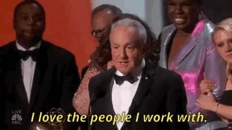 Lorne Michaels accepting an Emmy with the cast of SNL behind him, saying 