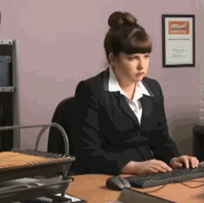 A girl sitting in front of a computer on her desk