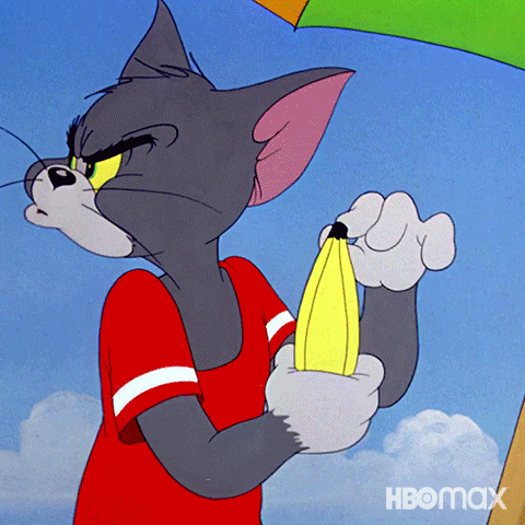 Tom the cat is peeling a banana to reveal Jerry in the peel.