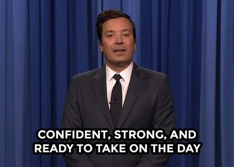Jimmy Fallon stands speaking in a suit while overlaid text reads, 