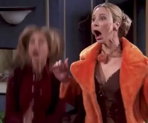 Rachel and Phoebe from friends jumping up and down while applauding.