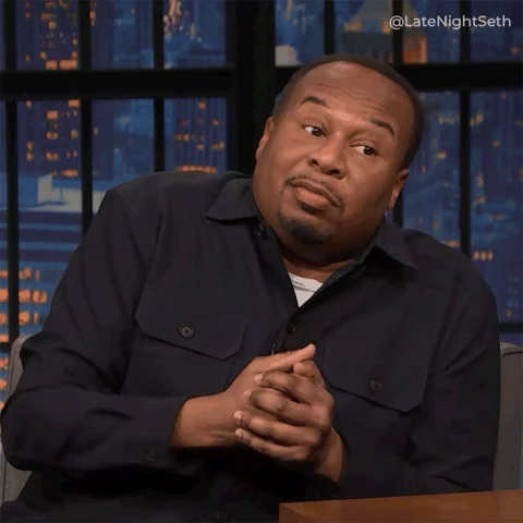  A man gestures with both hands while making an expressive face, suggesting emphasis or emotion.