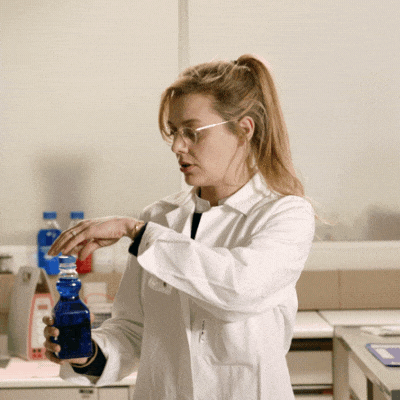 A professor in a lab opening a bottle. An animated cloud pops out.