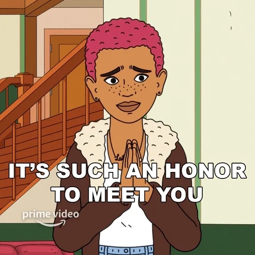 A person with short, pink hair, holding their hands together saying, 'It's such an honor to meet you.'