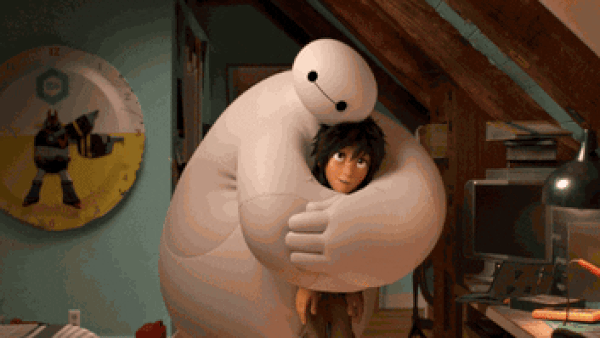 Baymax hugs Hiro and and pats his head in the movie 