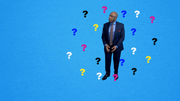A man in suit is confused and surrounded with question marks.