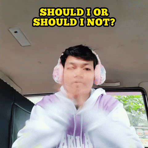 A girl wearing headphones rubbing her hands together and thinking.