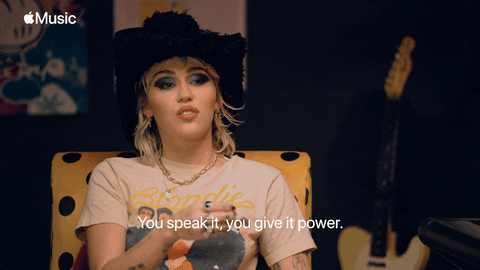 Miley Cyrus expressively saying 'You speak it, you give it power'
