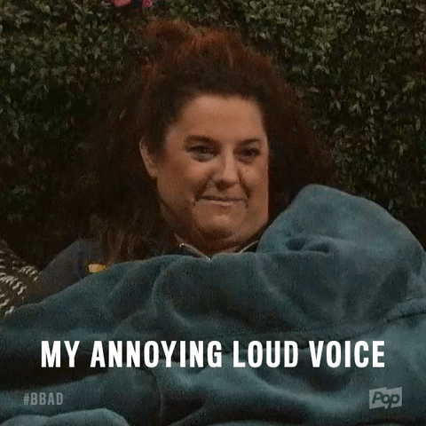 A woman laughs and says, 'My annoying loud voice.'