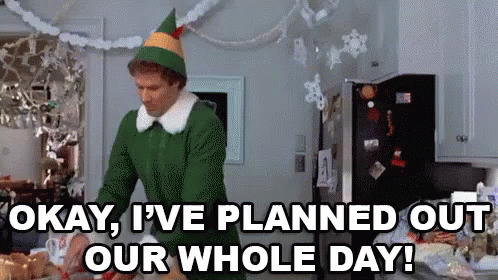 Okay I have planned out our whole day. Will Ferrel dressed as an Elf in a kitchen. Picks up a gift.