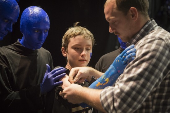 Bionic kid Wyatt trying on his bionic arm with the Blue Man Group