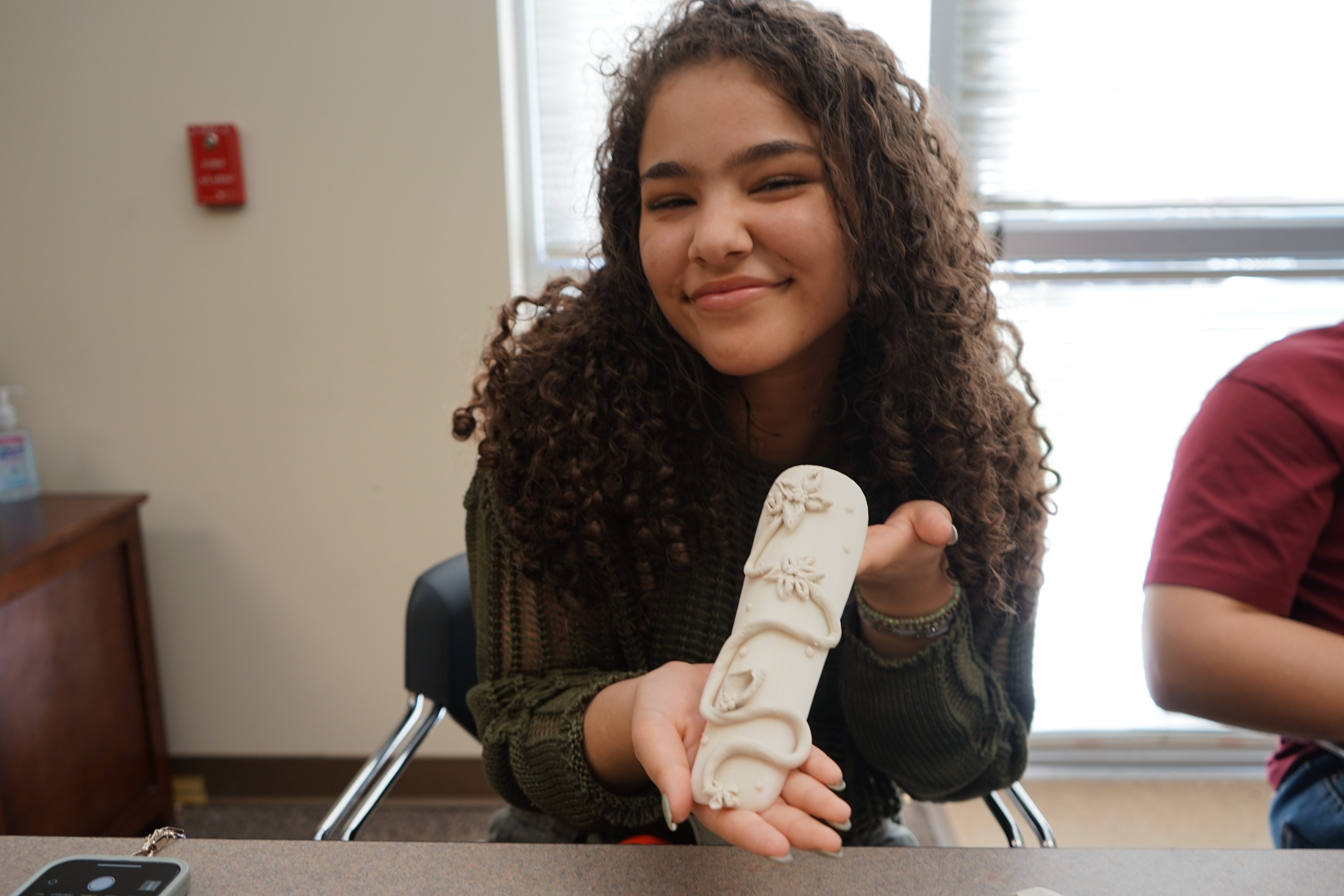 Student showing their project during a field trip event.