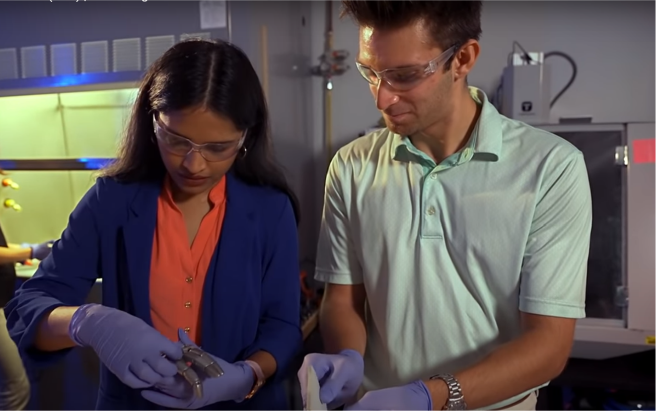 Image of Limbitless student Rishi Basdeo cutting materials at a work bench, pre-COVID19.