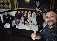 A DJ performing in a lively club setting